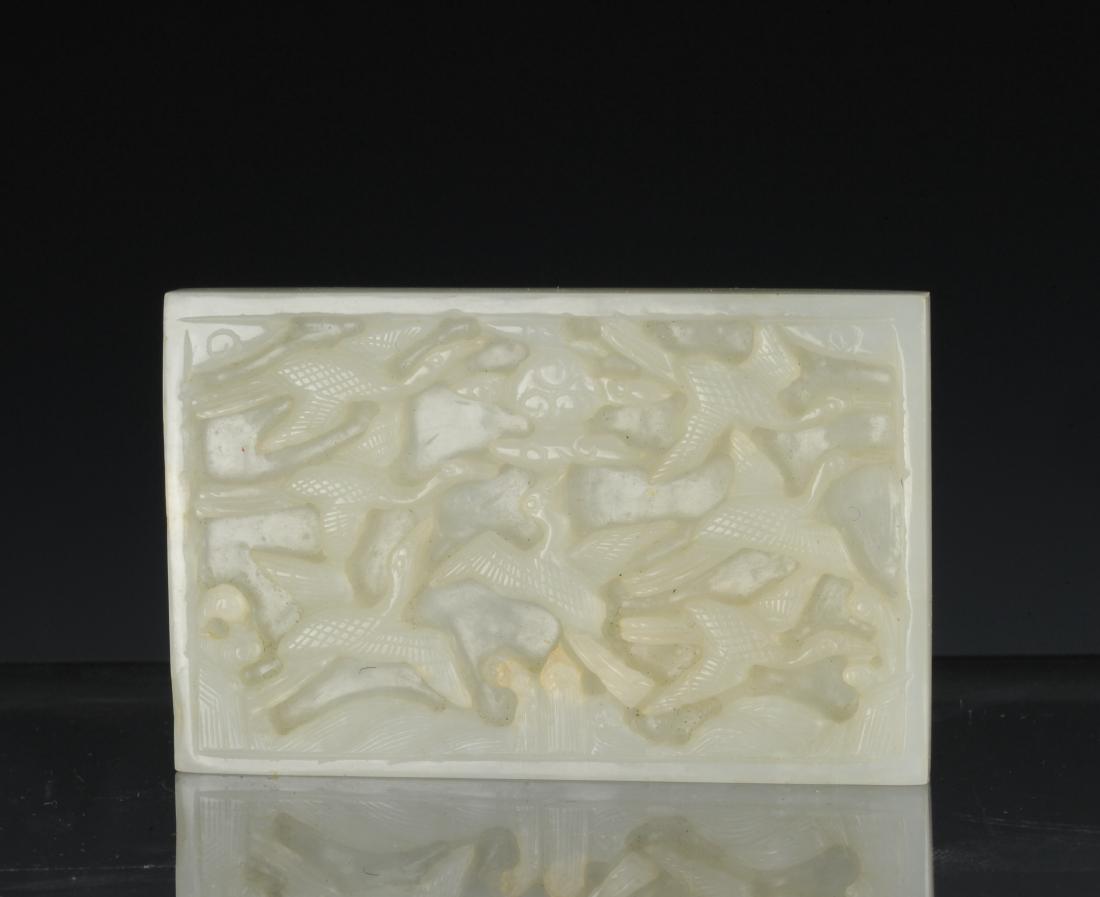 White Jade Plaque Carved with Cranes, Ming Dynasty: Rectangular white jade plaque carved with cranes from the Ming dynasty. The plaque is carved in bas relief with seven cranes. The back of the plaque is smooth except for the four pierced corners for s