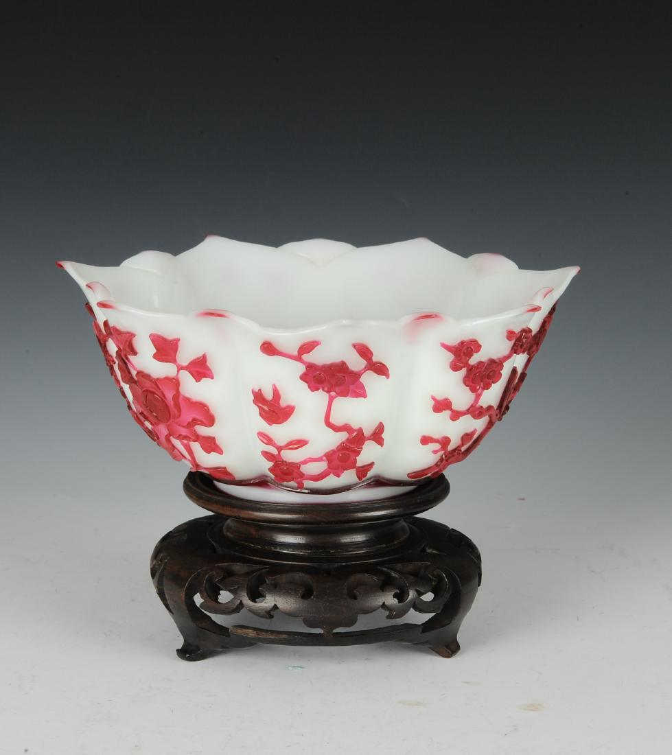 Peking Glass Bowl, 18th Century: Flower form Peking glass bowl from the 18th century. This lobed bowl is shaped like a lotus flower. The white glass has a red glass overlay of flowers and birds. It has no mark. The bowl comes with a