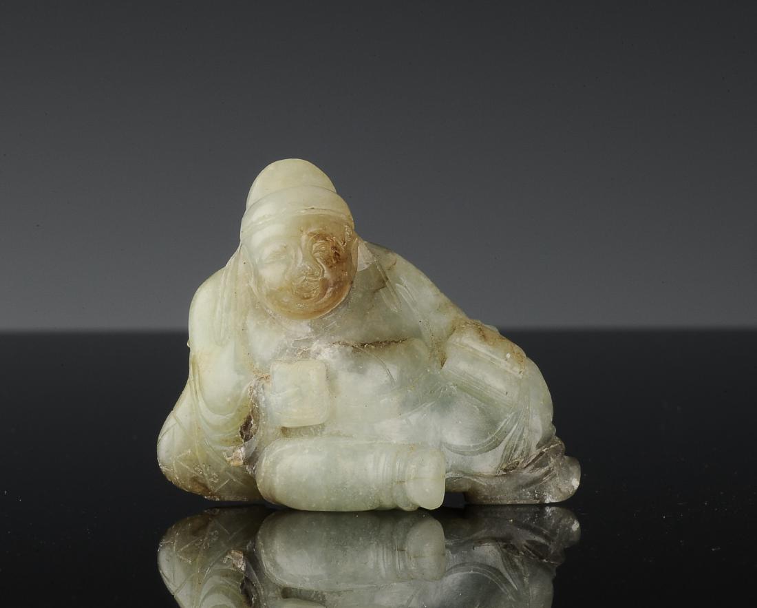 Jade Drunk Li Po Carving, Ming Dynasty: Jade carving of Li Po from the Ming dynasty. Carved out of grey-green jade, Li Po is depicted leaning off to one side with a cup in one hand and paper in the other. His wine jug rests behind him. Dime