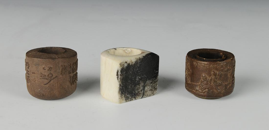 1 Jade & 2 Chenxiang Powder Archer Rings,18-19th C: One jade archer's ring and two agarwood (Chenxiang Powder) archer's rings from the 18th - 19th century. 1. Jade archer's ring is white with black mottling on the flat facade of the ring. Dimensions ar