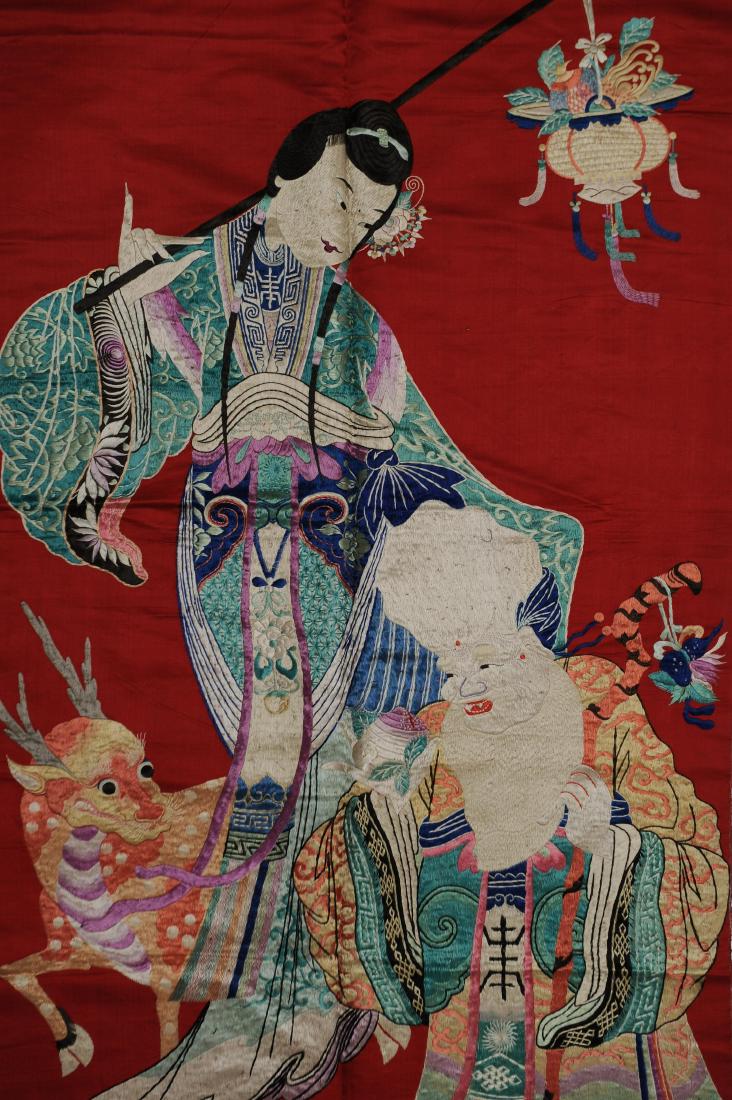 Magu Embroidery, Qing Dynasty: Embroidery on red silk of Magu from the Qing dynasty. Magu is gifting an old man fruit and blessings for long life. A deer stands by her side. Dimensions are 29 3/8 inches wide by 60 7/8 inches high. 