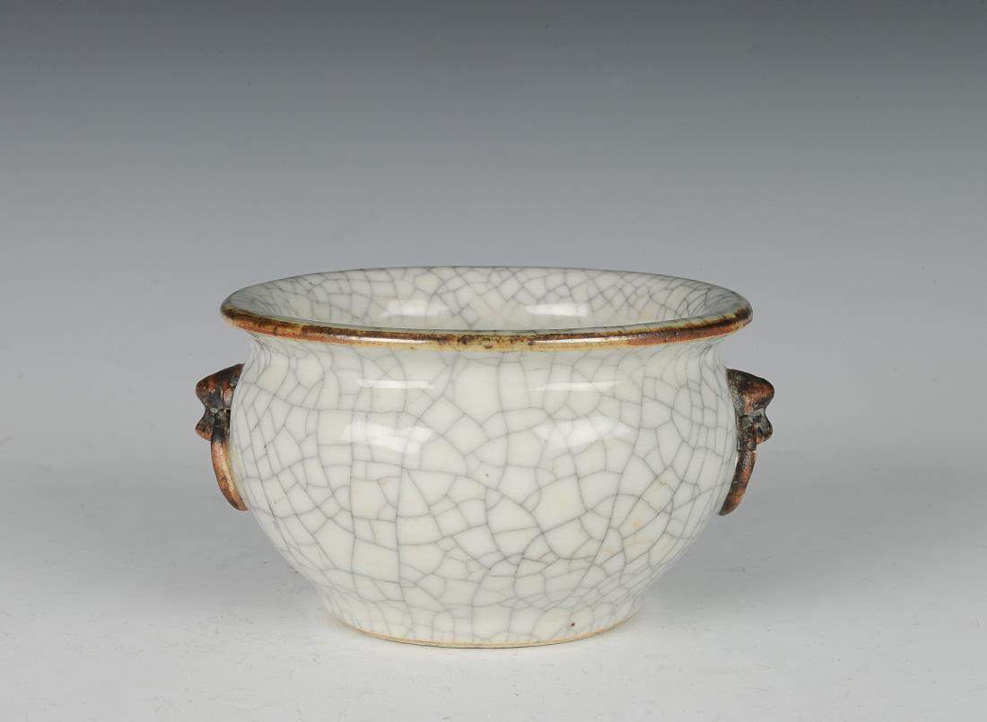 Ge Glaze Incense Burner, 18th Century: White ground, Ge glaze incense burner from the 18th century. The incense burner is simple and round in form with two beast head handles with matte brown glaze on either side. It has a four-character s