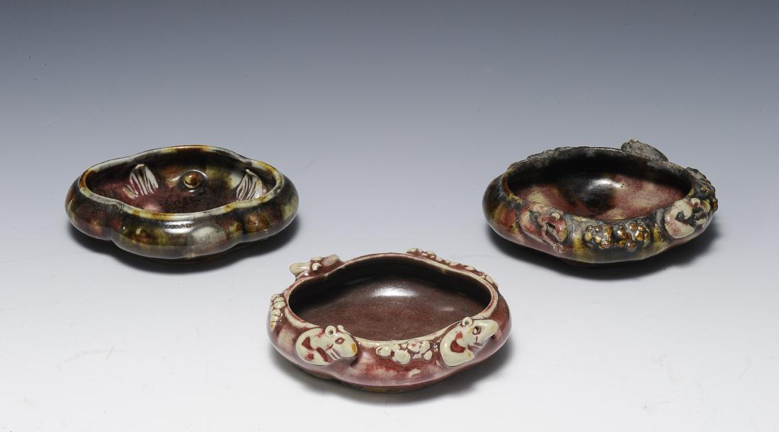 Three Red Glaze Begonia Form Brush Washers,19th Century: Trio of red glazed, begonia form brush washers from the 19th century. The quatrefoil or begonia form brush washers are shallow and glazed in a deep red color. Two of the brush pots are sculpted with s