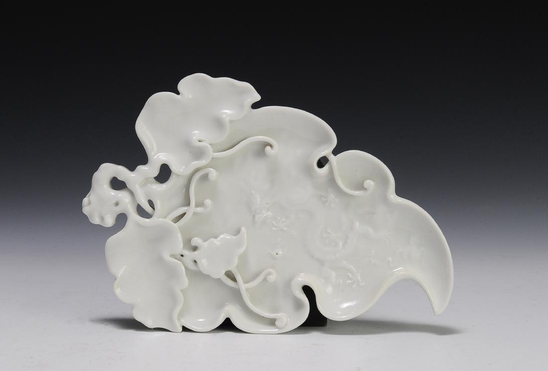 Blanc de Chine Brush Washer, 18th - 19th Century: Blanc de chine brush washer from the 18th - 19th century. This flat, leaf form brush washer is intricately sculpted with tendrils and leaves about one large central leaf. On the face of the brush wash