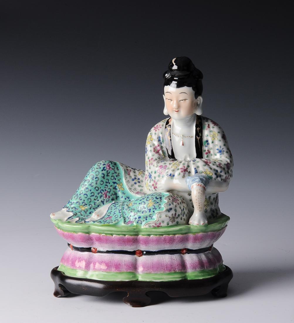 Porcelain Figure of a Lady, Republic Period: Porcelain figure of a lady from the Republic period. The lady reclines on a lotus form base. The lady is dressed in robes with floral designs. The bottom is stamped with characters within a diamond an