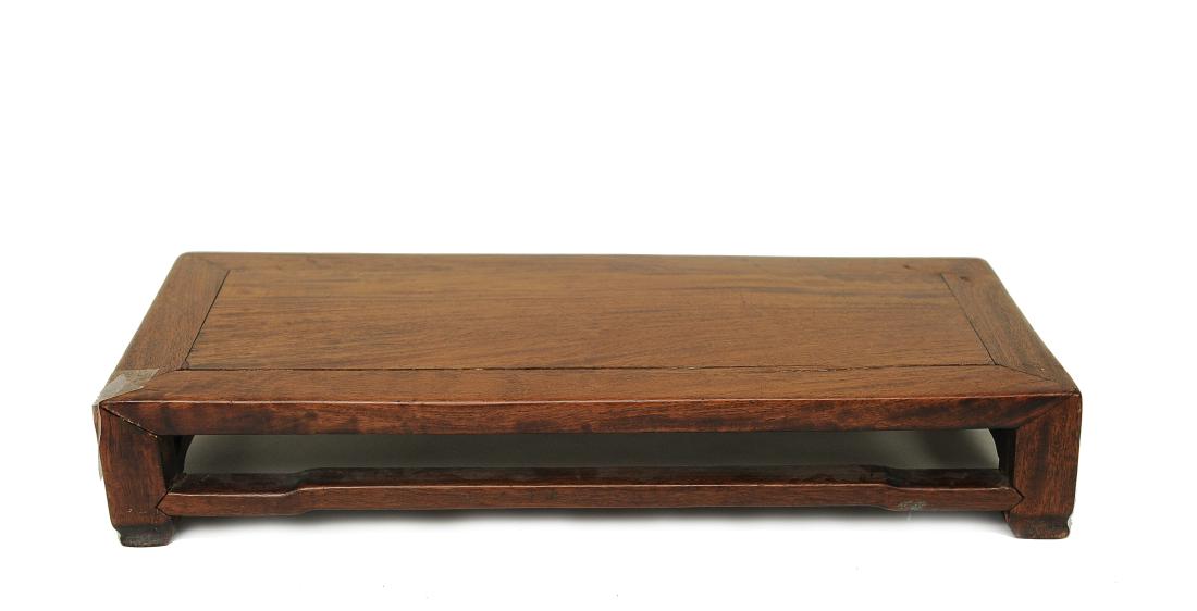 Huanghuali Foot Board, 17th Century: Huanghuali foot board from the 17th century. This long, rectangular foot board is minimalist in design. It has four stretchers and four feet. Dimensions are 10 1/4 inches wide by 23 inches deep by 3 7