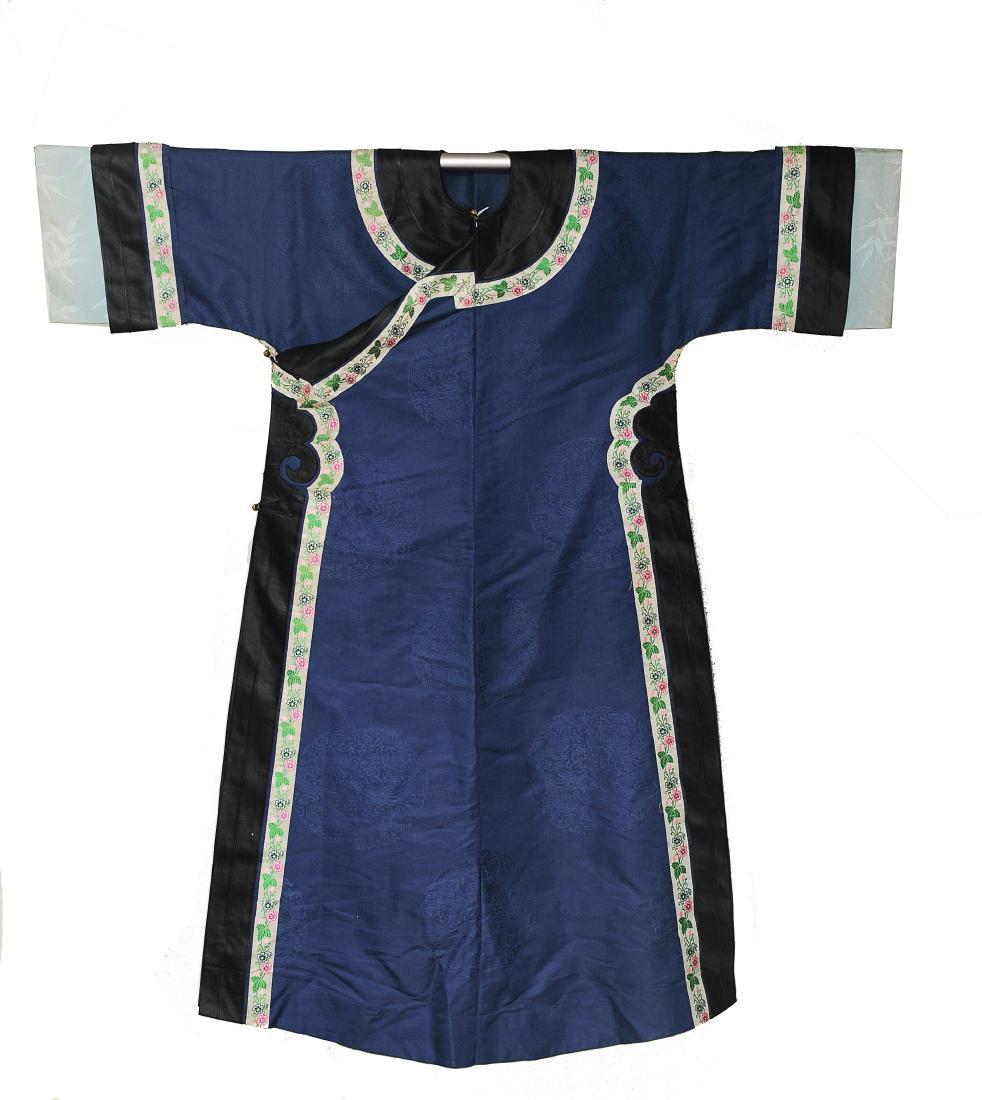 Lady's Robe, 19th Century: Dark blue ground silk lady's robe from the 19th century. Dragon medallions are visible in the pattern of the blue silk. The robe has a floral border and black trim around the sleeves, sides, and colla