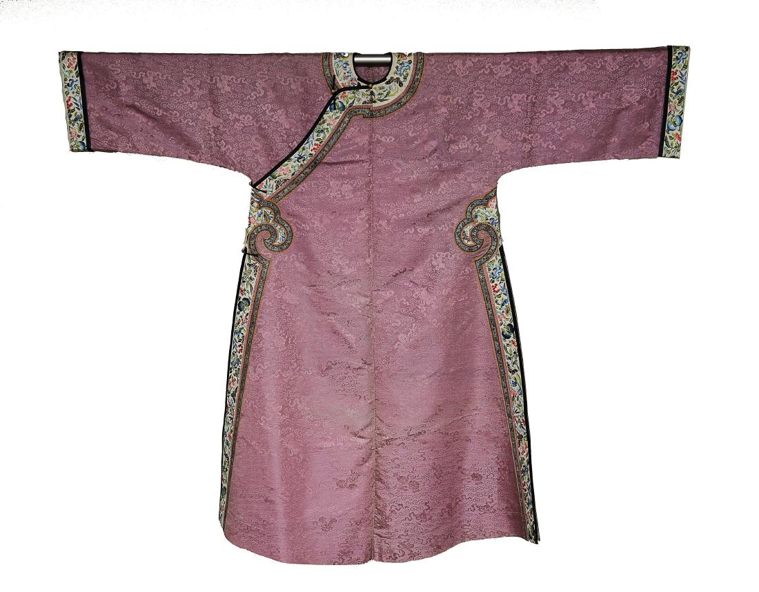 Lady's Robe, Early 19th Century: Rose pink silk lady's robe from the early 19th century. Auspicious symbols are included in the pattern of the rose pink silk. The robe has white trim embroidered with butterflies and flowers. Dimensio
