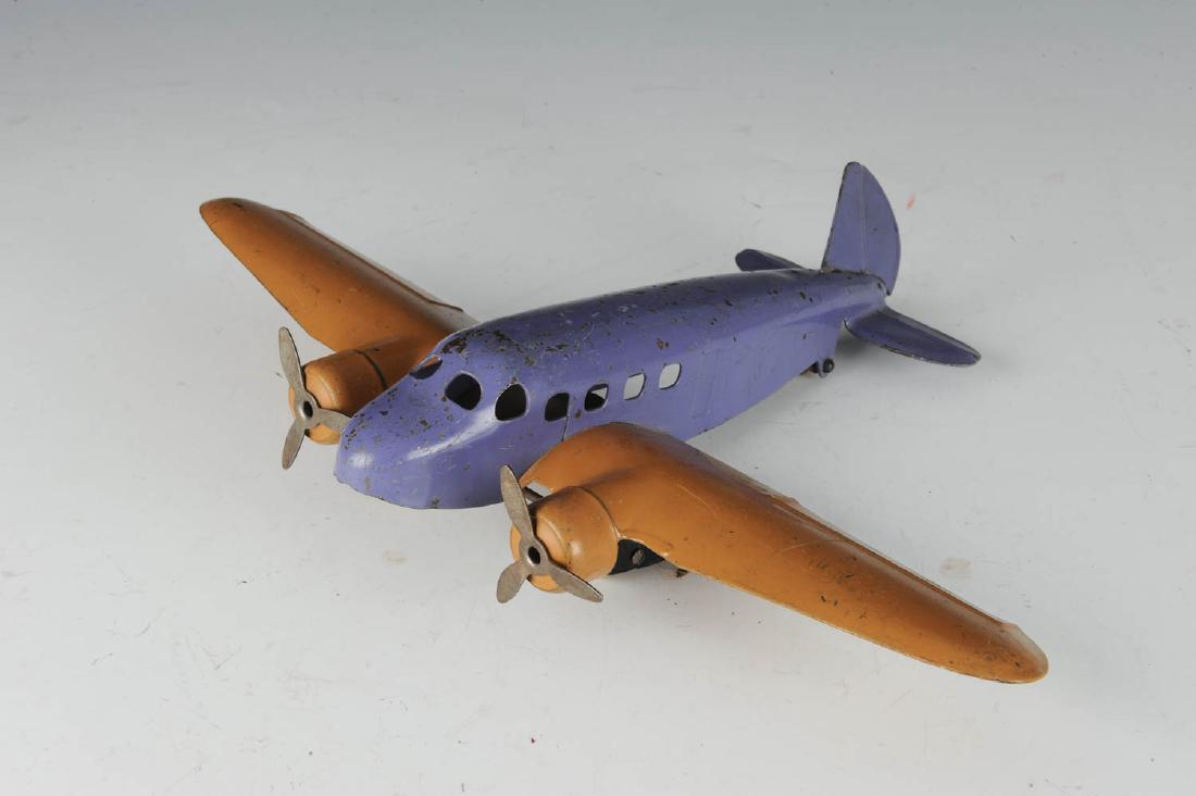 Wyandotte Pressed Steel DC3 Airplane: Rare color scheme of purple and tan. All original. Dimensions are: 12 7/8" WS X 9 5/8" long. All measurements are approximate.