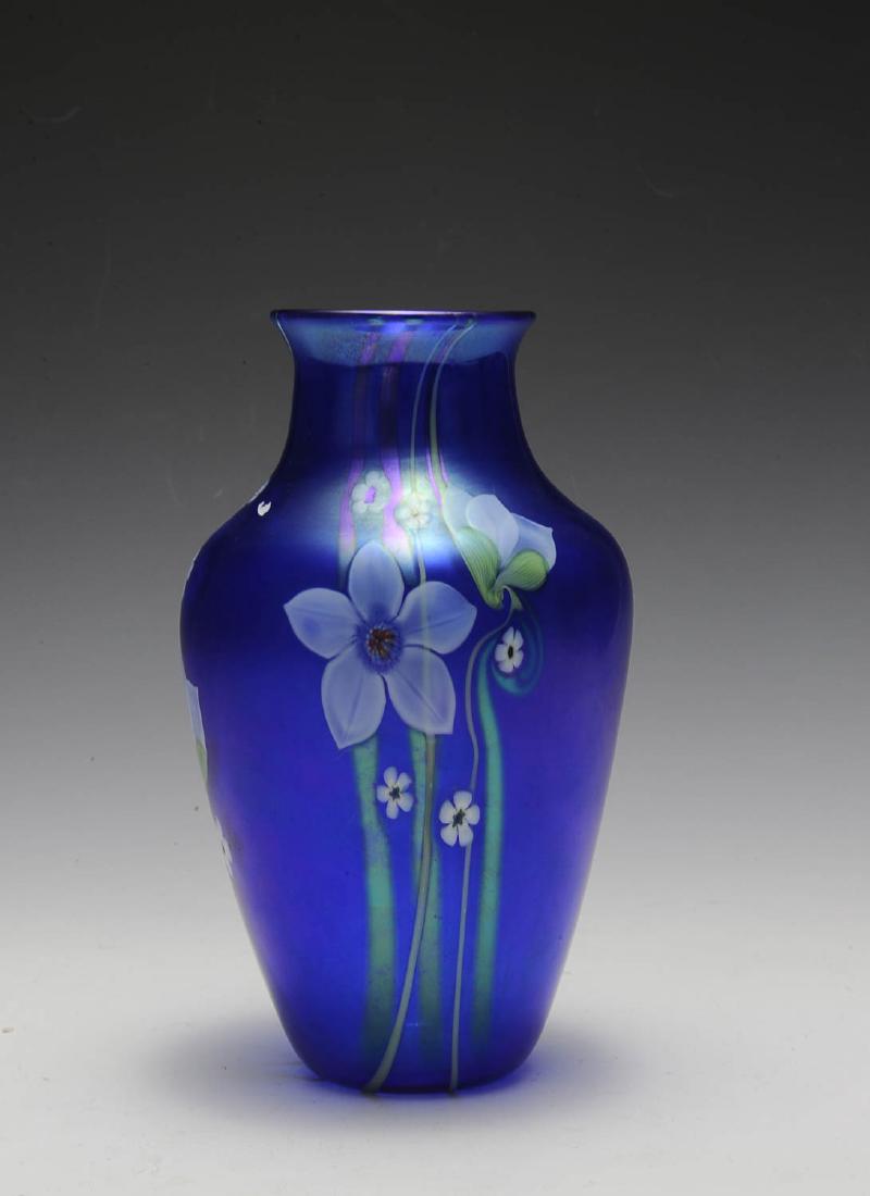 Orient & Flume Iridescent Flower Vase: Retains paper label, dated 1984, marked O5. Dimensions are: 9 1/4" tall. All measurements are approximate.