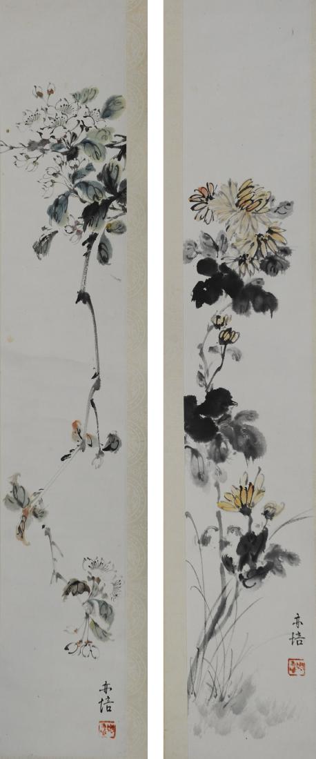 Pair of Paintings of Flowers by Zhou Yipei: A pair of paintings of flowers by Zhou Yipei. Each has a signature and 1 seal and is color on paper with a silk backing and dowel. Dimensions are 27 inches tall X 4 1/2 inches wide. All measurements a