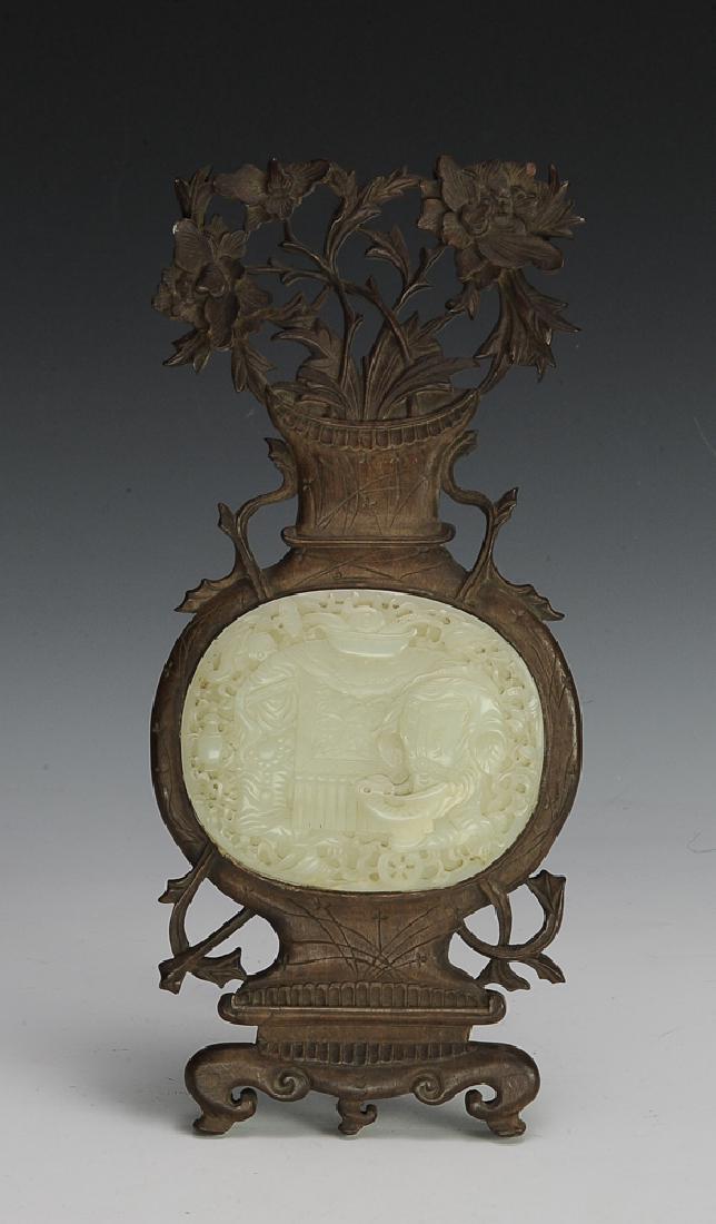 Chinese Jade Plaque w/ Wooden Frame, 18th C: Oval jade plaque carved with an elephant surrounded by 8 Buddhist symbols. The plaque has been glued to a wood frame in the form of a vase with flowers. The frame can stand upright. Dimensions for the