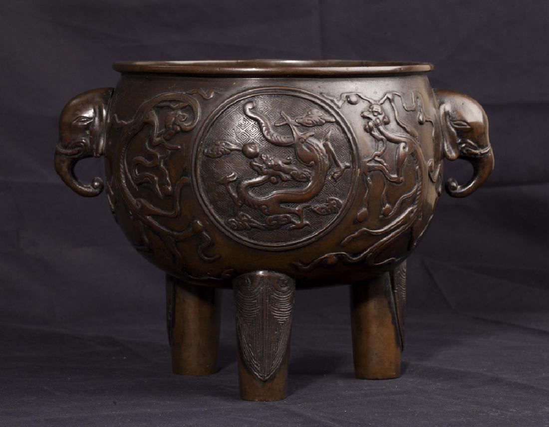 Bronze Tripod Incense Burner, 19th Century: Bronze tripod incense burner from the 19th century. Molded with dragon medallions and chilong, with elephant handles on each side and supported by three cylindrical legs. Dimensions are 7 inches tall 