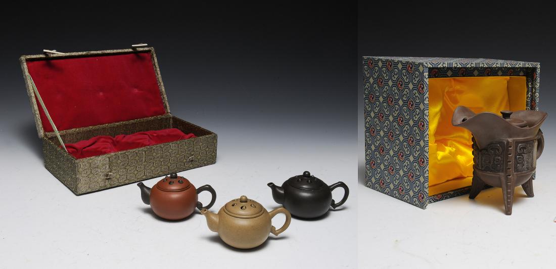 3 Yixing Teapots & Earthenware Vessel w/ Box,China: A boxed set of 3 Yixing teapots in tan, red, and dark brown clay with rattles in the lids, and a boxed earthenware wine vessel with lid. Dimensions are: each teapot measures 2 1/2 inches tall X 4 1/2 