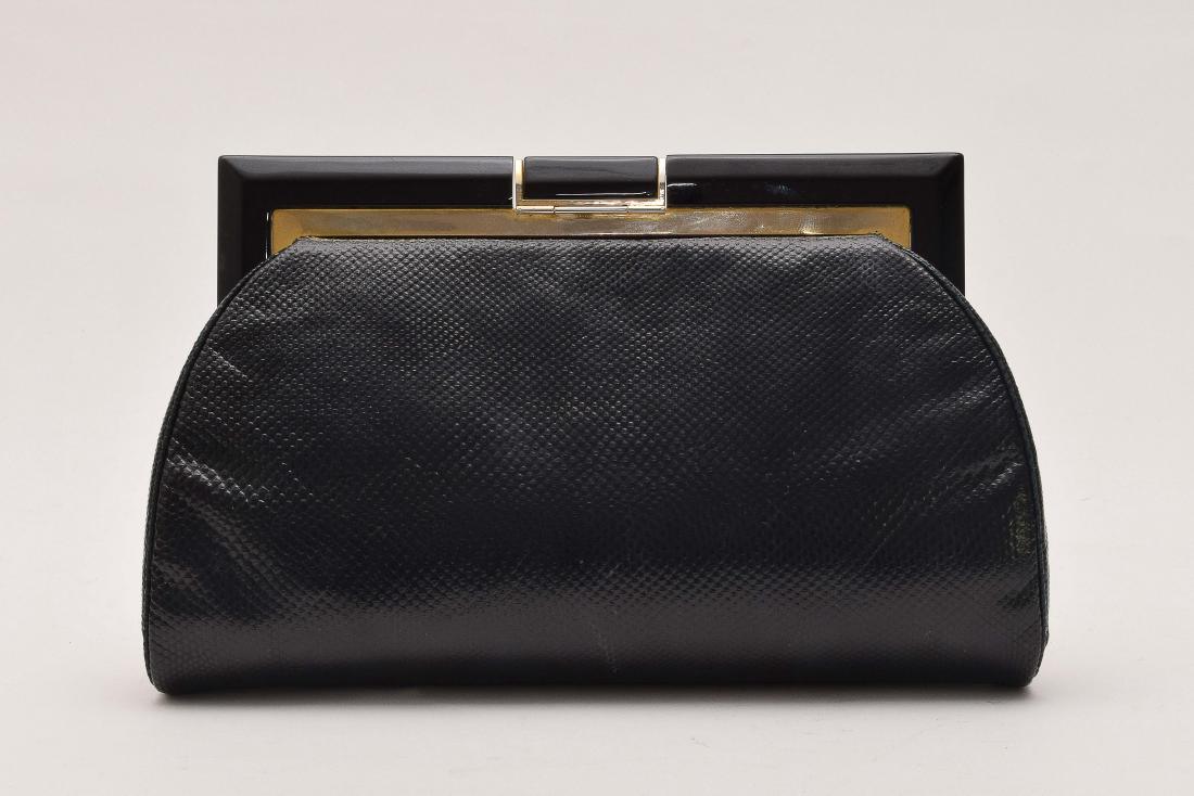 A Vintage Lambskin Clutch by Judith Leiber: Clutch has a black and brass frame and clasp. Comes in an original signed Judith Leiber protective bag. Dimensions are: 6" tall X 9 1/2" long. All measurements are approximate. Condition: Minor us