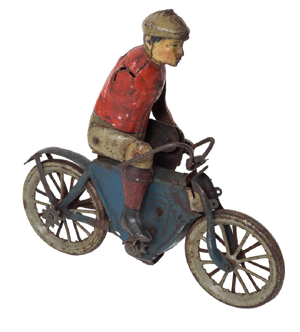 Gunthermann Tin Clockwork Motorcycle: Tin, clockwork motorcycle made by Gunthermann in pre-war Germany. Blue motorcycle with grey tires and rider in red cycling outfit. Dimensions are: 7 1/2" tall X 7 3/4" long. All measurements are app