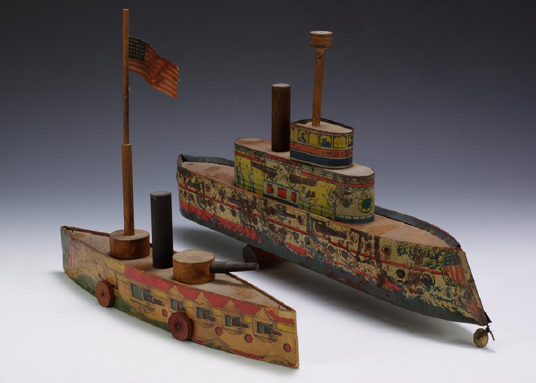 2 Lithographed Boats by Converse: One is paper litho and one is a lithographed tin boat. Both have wood components. Dimensions are: largest is 10" tall X 18 3/8" long. All measurements are approximate. Paint wear to tin litho and oxid