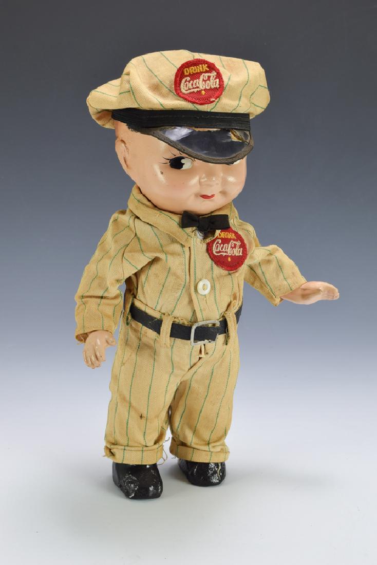 Buddy Lee Composition Coca-Cola Doll: Complete and original. Dimensions are: 13" tall. All measurements are approximate. Hat brim is cracked, Very Good - Fine.