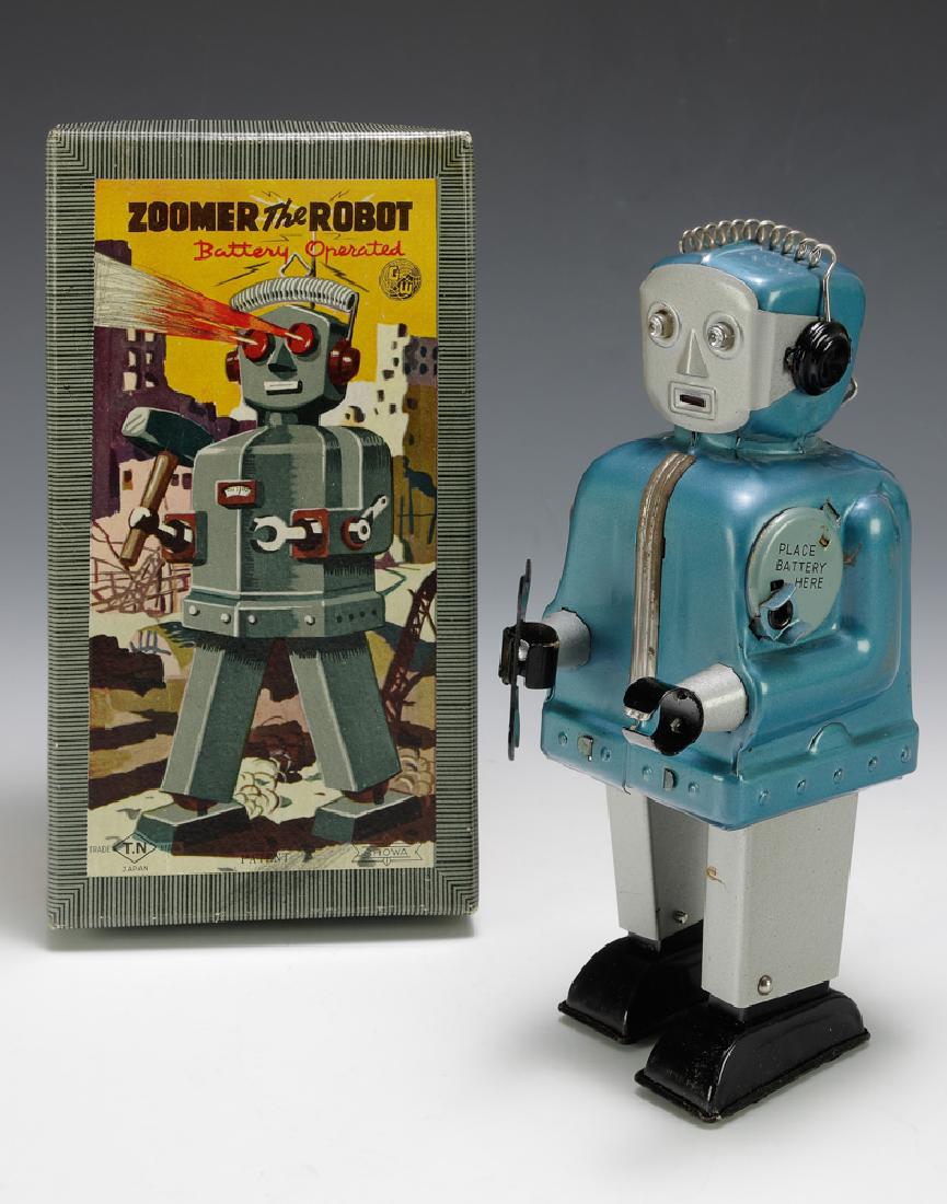 Boxed Zoomer Robot by Nomura: Blue & silver version. Dimensions are: 7 7/8" tall. All measurements are approximate. A few small rubs to blue body. Red wire in battery compartment detached. Excellent. Original box is crisp and exce