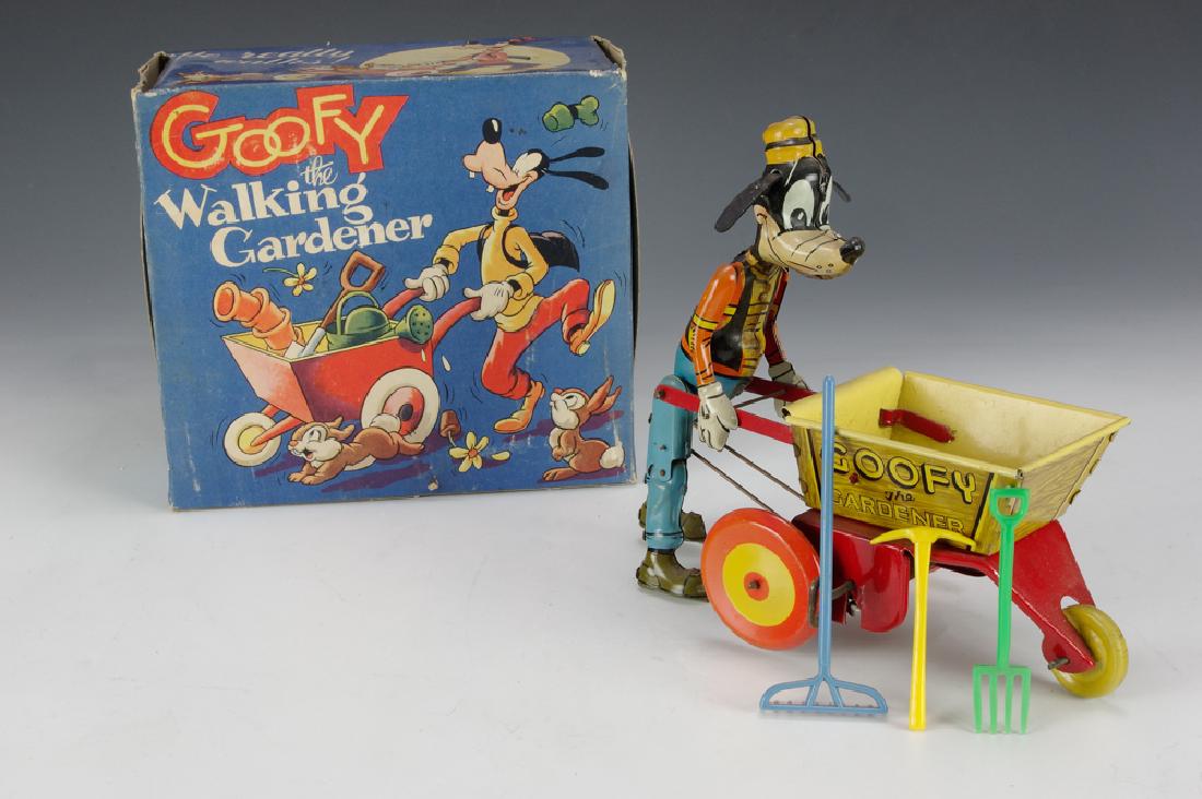 Goofy the Gardener w/ Original Box, Marx: Goofy the Gardener, tin litho toy with hard rubber ears and original plastic tools. This windup toy comes with the rare original box. Marked with Marx logo and 'Made in GT Britain'. Dimensions are: 7 
