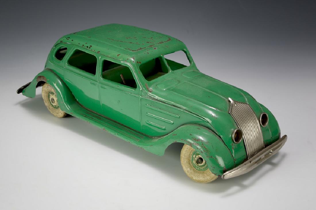 Kingsbury Windup DeSoto Airflow Sedan: Pressed steel windup DeSoto Airflow sedan by Kingsbury. Car has original green paint and tires are marked with 'Kingsbury Toys, Pat'd Keene NH, USA.' It has electric headlamps and taillight. Dimension