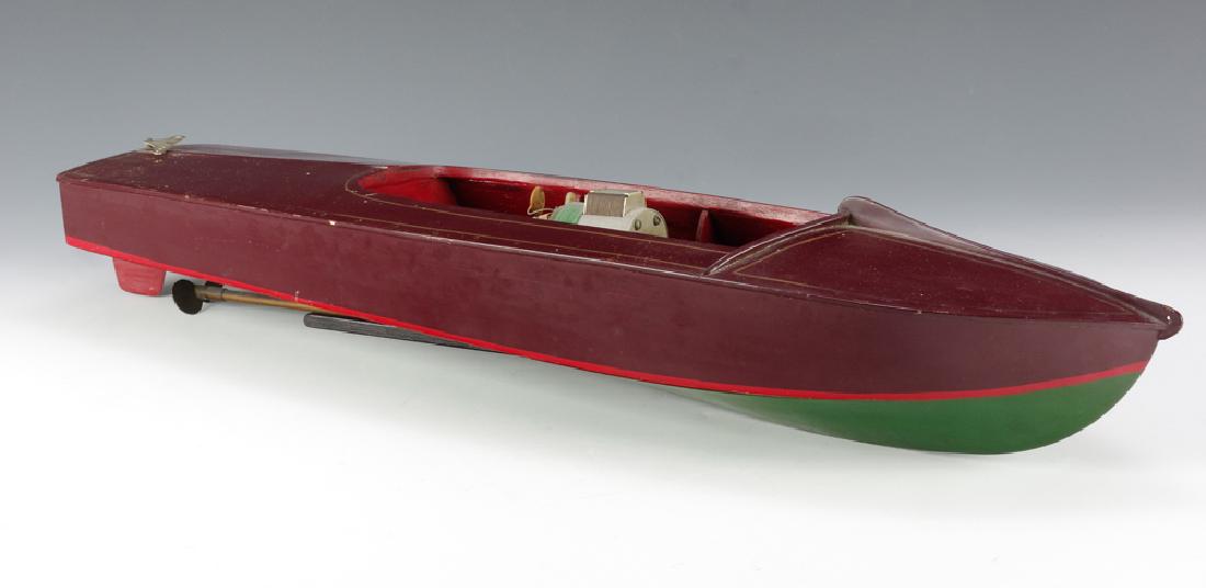 Wooden Speedboat w/ Electric Motor: Wooden boat painted a deep red and green with gold pinstripe. Stern is marked with 'Powered by Dennymite'. Engine is marked with 'Super Pittman Panther Boat Motor'. Dimensions are: 26" long X 7 /58"
