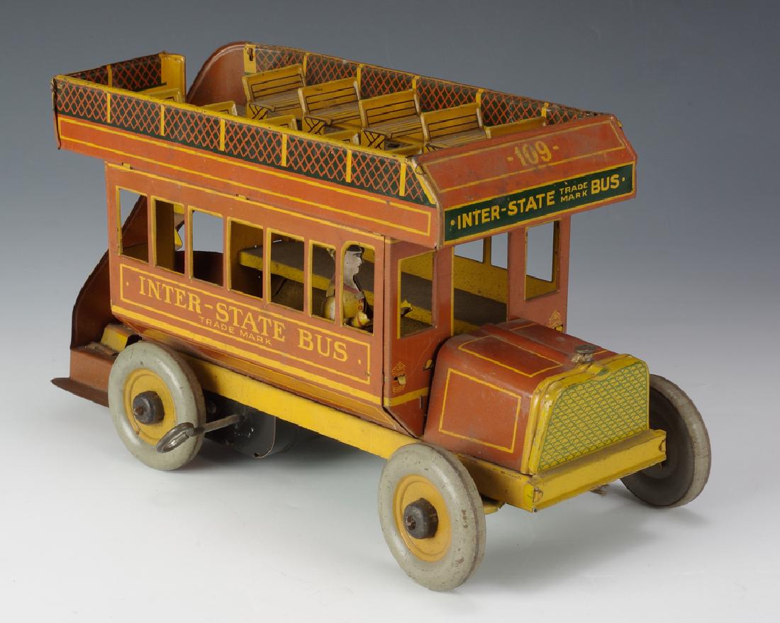Strauss Inter-State Bus: Windup, red and yellow tin 'Inter-State Bus' by Strauss. Marked with 'Trademark' below name. Bus #109. Bus has a back staircase, upper deck and driver. Marked with 'Strauss Mechanical Toys" and compan