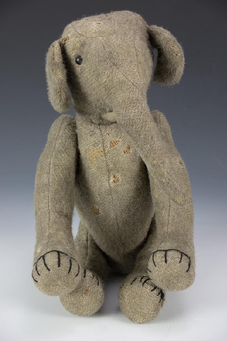 Rare Early Burlap Jointed Elephant Circa 1910: German,either Steiff or Strunz with original shoe button eyes. Dimensions are: 15" long. All measurements are approximate. Several scattered moth holes, mostly to chest. Left leg has joint wire protru