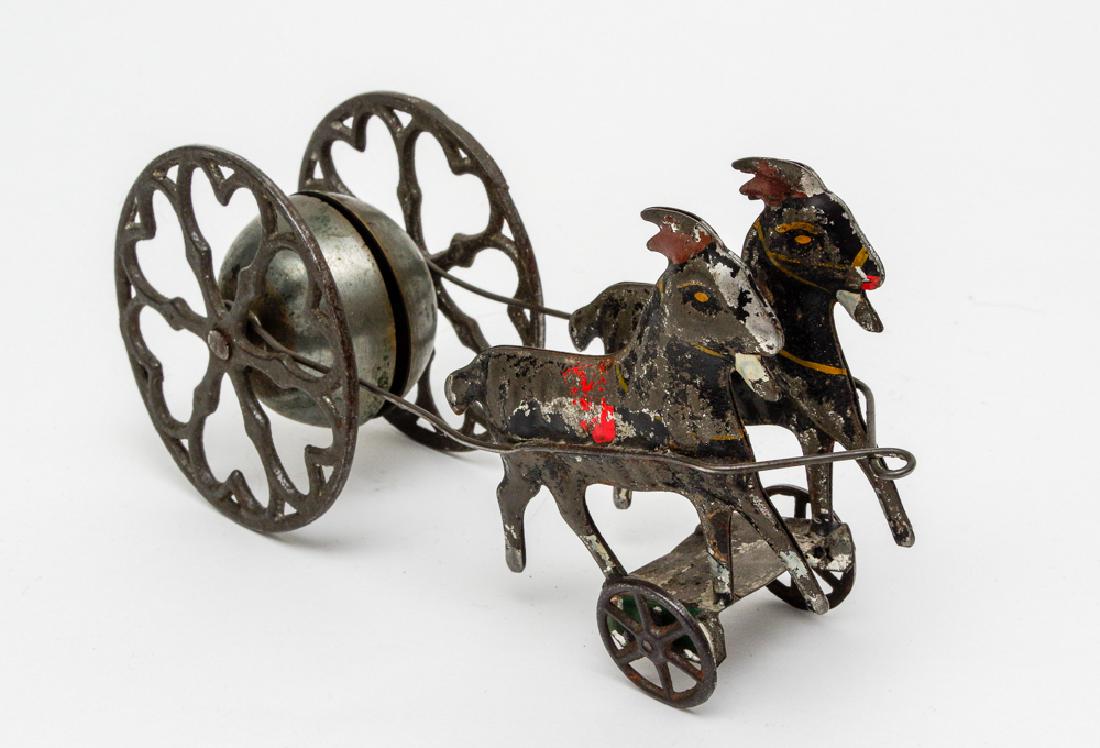 Early American Tin & Iron Bell Toy: A metal bell toy with 2 donkeys pulling a chariot. Dimensions are: 3 1/2" tall X 6 3/4" wide. All measurements are approximate. Play wear, Good