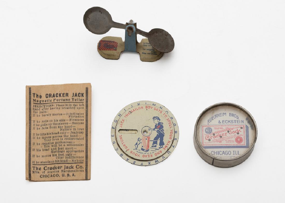 Cracker Jack Premiums Inc.Magnetic Fortune Teller: Group includes: rare Magnetic Fortune Teller in original sleeve, Rueckheim Bros. & Eckstein Cracker Jack palm puzzle, Cracker Jack Decoder, and a Checkers Candy tin scale. Dimensions of largest object