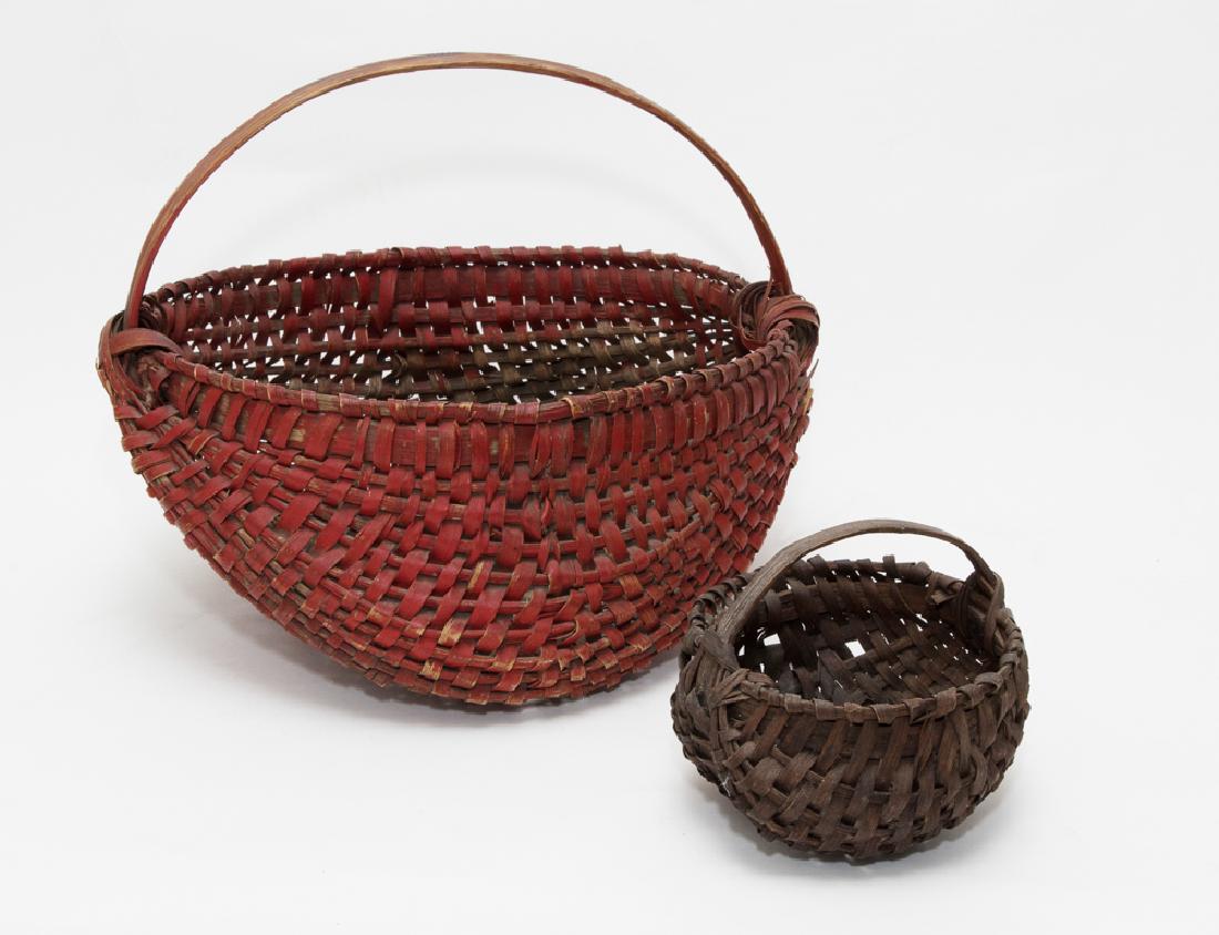 Pair of Egg Baskets: AKA as buttocks baskets due to shape. The larger basket is painted red on the exterior, the smaller is plain. Dimensions are: 12" tall X 14 1/2" wide. All measurements are approximate. Condition: Both