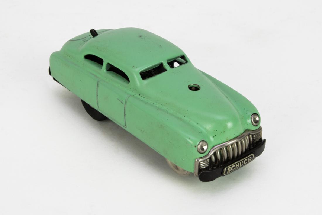 Schuco 3041 Car with Winding Key & Track, with Box: The bottom is marked with "Made in Western Germany, Schuco, Patent Varianto-Limo 3041." The rear window of the toy car has 4 settings. It comes with a winding key, plastic intersection, and track. D