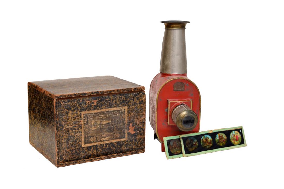 Boxed Magic Lantern with Slides by Ernst Plank: Painted Tin in original wood box. Retains original lamp and comes with 25 full color slides. Dimensions are: 11 1/2" tall. All measurements are approximate. Condition: Some use, age wear. Very Goo