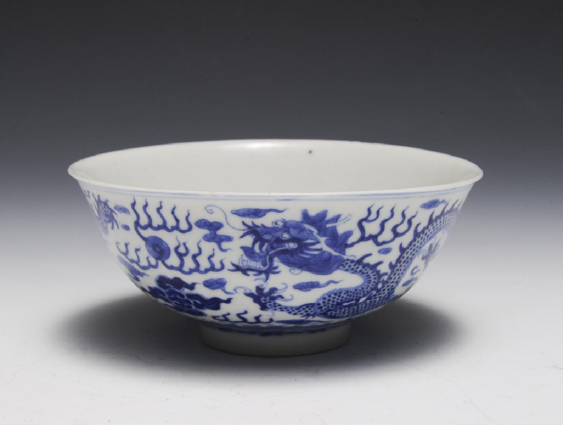 Chinese Imperial Blue & White Dragon Bowl, Guangxu: A Chinese Imperial blue and white porcelain dragon bowl. There is a 6-character Guangxu mark on the bottom and it is of the period. The bowl depicts 2 5-clawed dragons chasing flaming pearls against a