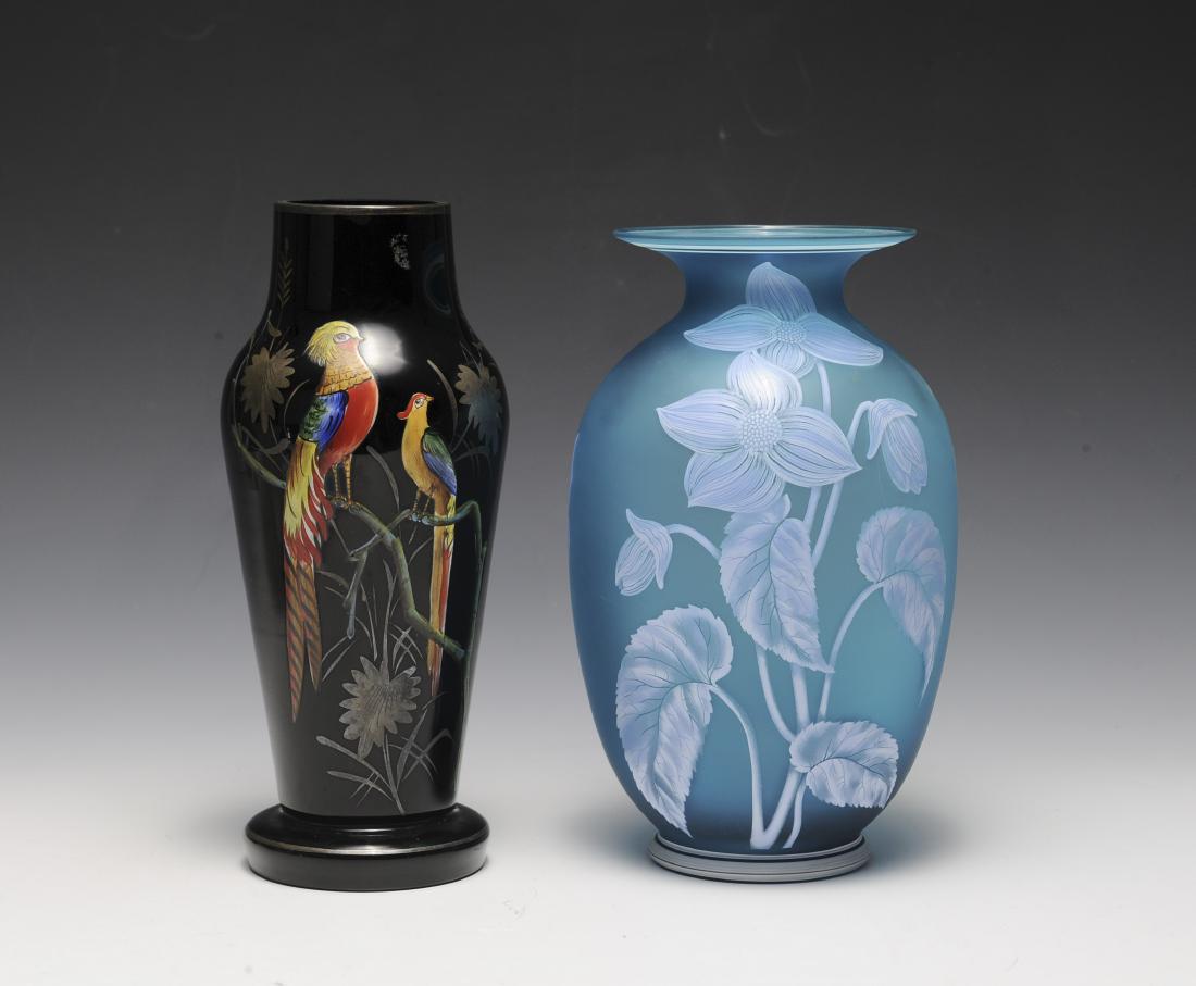 Two 1930s Hand Painted Glass Vases: Blue satin glass with flowers, leaves and butterflies by Fenton for Avon and a black Czech glass vase with birds. Dimensions are: largest 9 3/8" tall. All measurements are approximate. Condition: No n