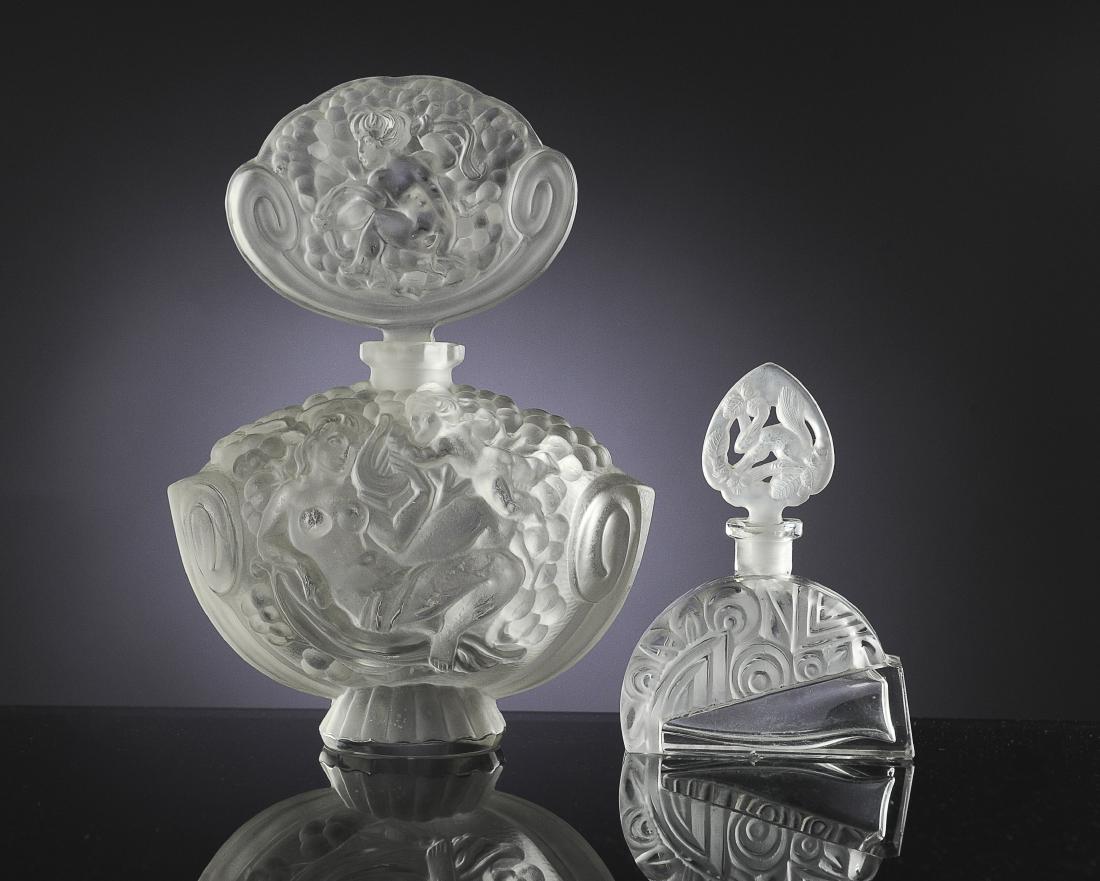 Two 1920's Perfume Bottles: Unmarked opalescent glass bottle, French or Czech, and one with a frosted glass abstract design and squirrel stopper marked 'Made in Czechoslovakia'. Dimensions are: largest 4 13/16" tall. All measure