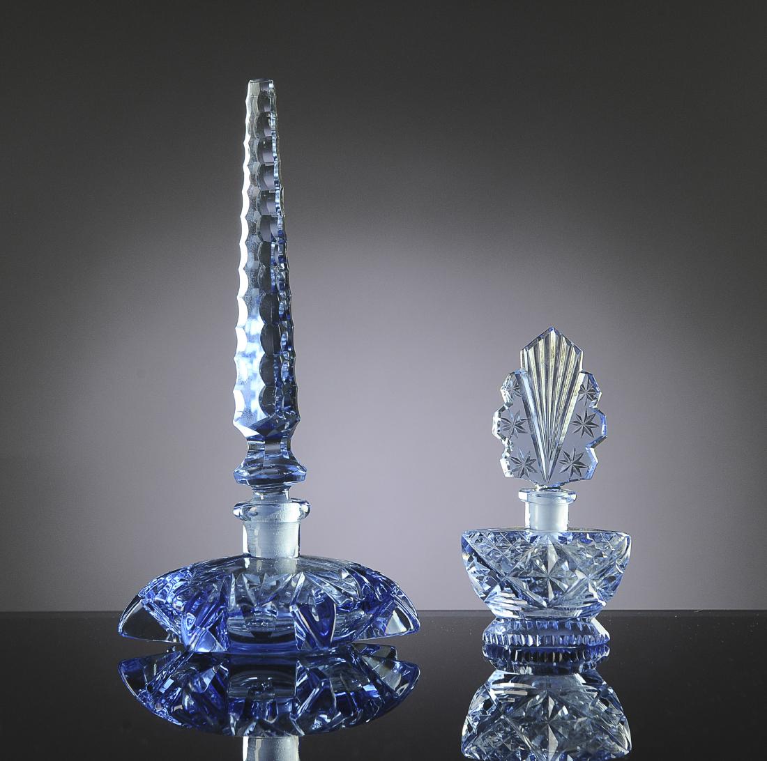 Two Czech Blue Geometric Perfume Bottles: Both marked 'Made in Czechoslovakia' on bottom. Larger has six pointed star bottle and a spire form stopper. Dimensions are: largest 8 1/8" tall, 4 5/16" wide. All measurements are approximate. Condit