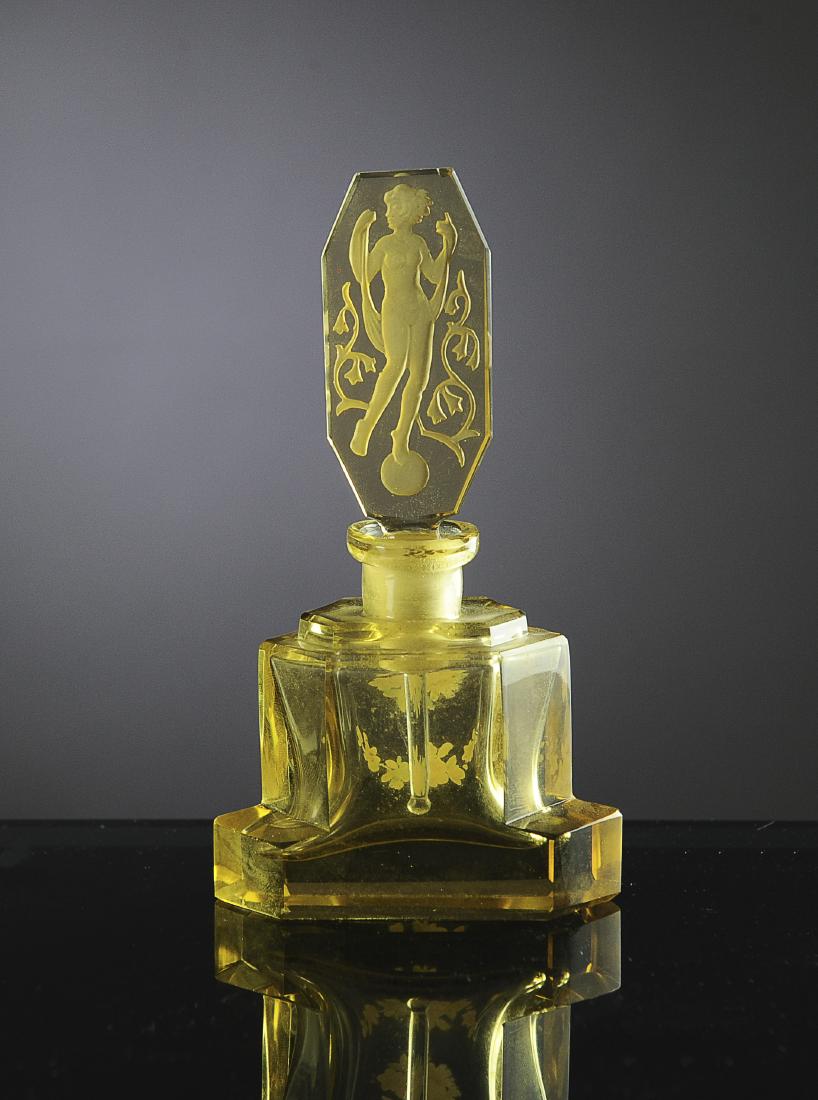 Amber Art Deco Czech Perfume Bottle with Nude: Intaglio stopper has wand. Bottle marked 'Made in Czechoslovakia'. Dimensions are: 5 1/8" tall. All measurements are approximate. Condition: Small chip to top edge of stopper. Fine. Provenance: The li