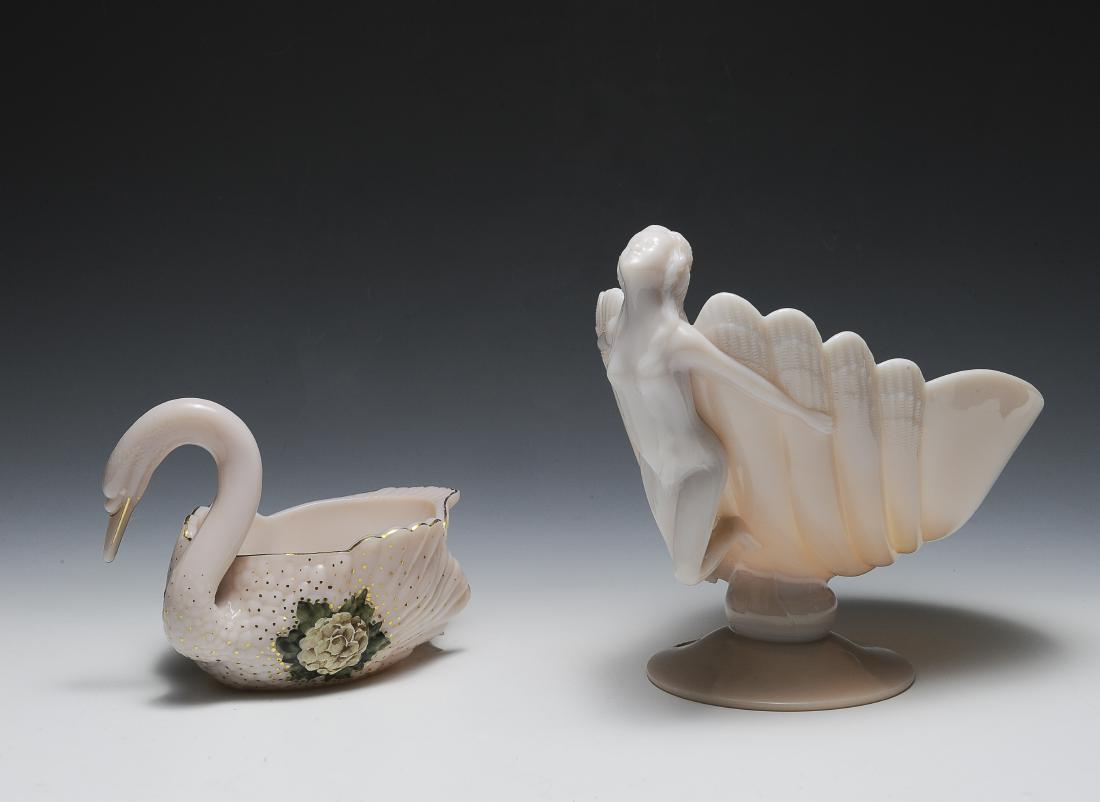 Two Cambridge Glass Bowls: Two Cambridge glass bowls. One is in the shape of a seashell with a nude female in Crown Tuscan. The other bowl is swan-shaped and in Carleton. Dimensions are: largest 9" long, 7 1/2" wide, 9" tall. A