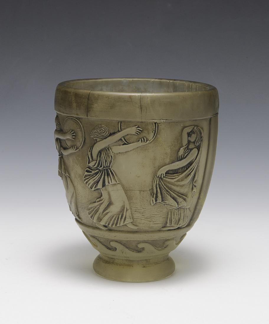 Satin Glass Vase by Georges de Feure: Classical images of female musicians in relief. Signed 'G. de Feure' on base. Dimensions are: 5" tall, 4 5/8" dia. All measurements are approximate. Condition: A couple hairlines to rim. Very Good. Pr
