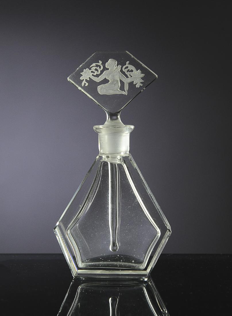 Crystal Clear 1920s Czech Perfume Bottle: Simple clean lines to bottle. Intaglio stopper with a kneeling woman and retaining wand. Dimensions are: 4 7/8" tall. All measurements are approximate. Condition: No noted damage. Excellent. Provenanc