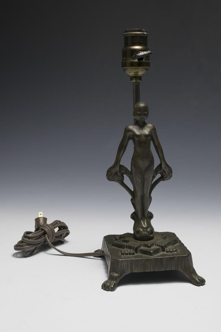 An Art Deco Cast Iron Lamp Base with Nude: Signed under claw foot base 'A.S. and 624'. Unknown maker. Dimensions are: 12 3/4" tall, 5 1/4" wide. All measurements are approximate. Condition: Surface wear, especially to figure. Very Good - Fine.