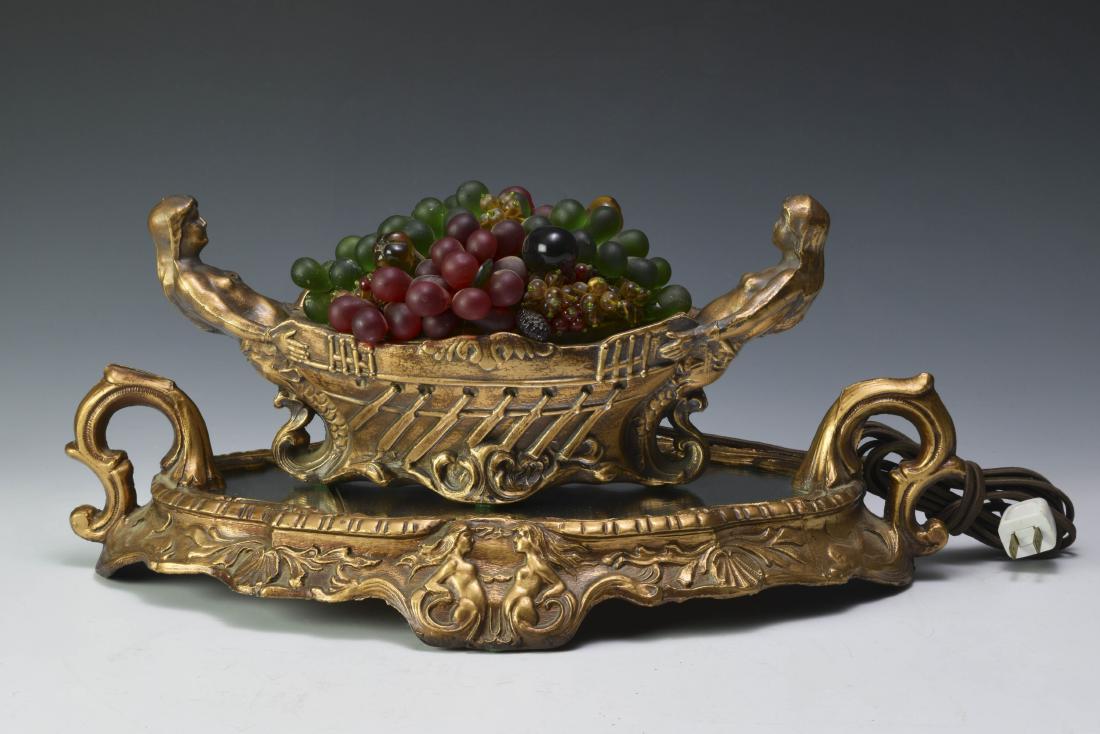 Czech Fruit Basket Mermaid Lamp on Mirrored Base: Spelter lamp with mermaid ends on original mirrored base, base marked 'Aljag Light Fixt. Co.' Dimensions are: lamp 12 1/2" long, base 17 1/2" long, overall 8" tall. All measurements are approximate. C