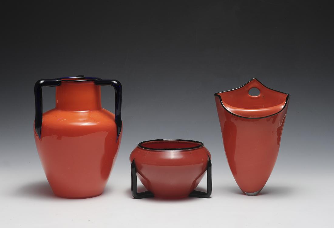 Three Red Czech Glass Vases: Three red Czech vases with black or dark blue trim. Dimensions are: largest 8 1/4" tall, 5 1/2" dia. All measurements are approximate. Condition: Some faint scratches. Very Fine - Excellent. Provenanc