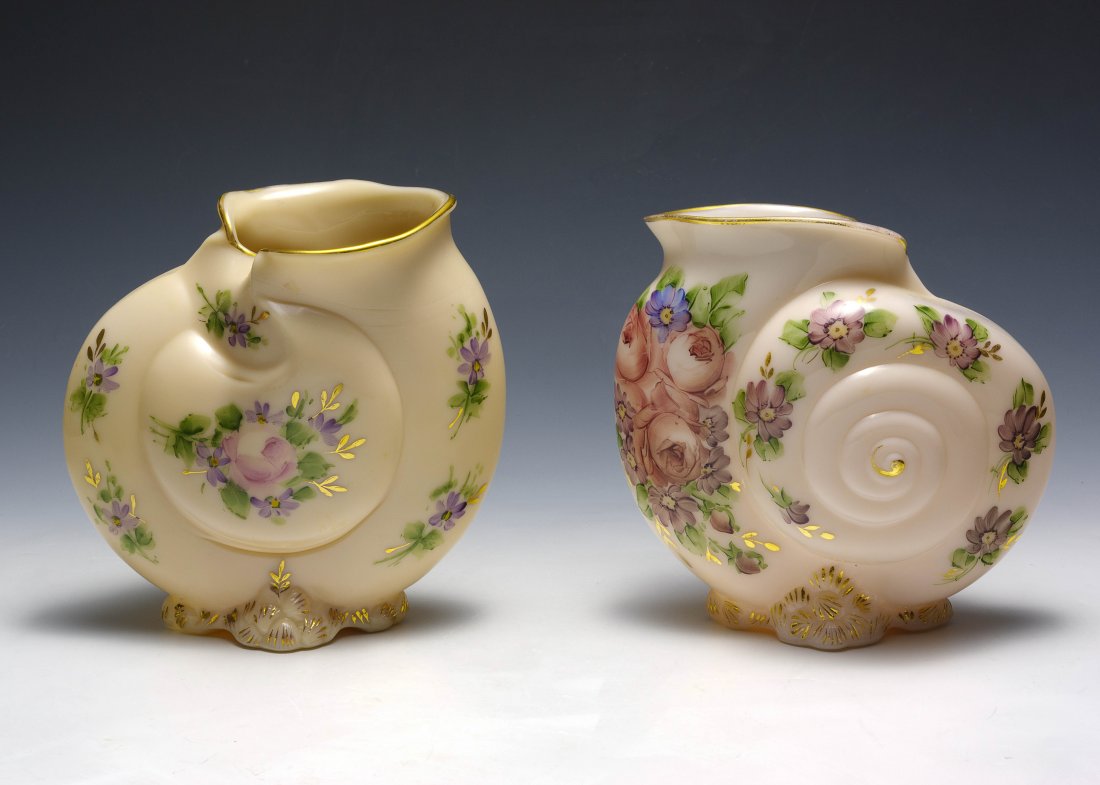 Two Cambridge Glass Charleton Seashell Vases: Two Cambridge glass Charleton vases shaped like seashells and decorated with purple and pink flowers. Dimensions are: 7 3/4" tall. All measurements are approximate. Condition: Some loss of gold trim. 