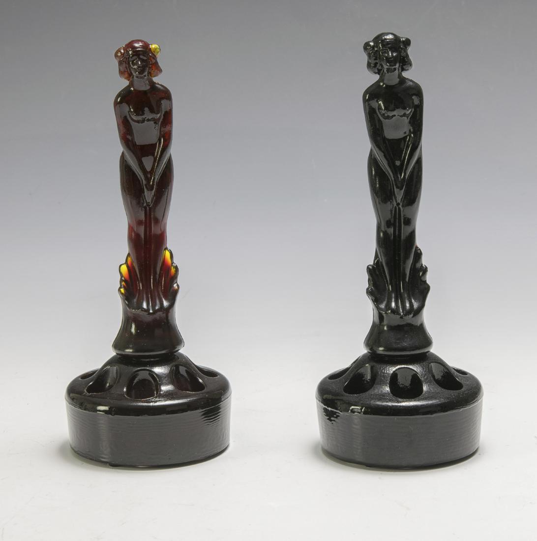 Two Fenton "September Morn" Flower Frogs with Nudes: Fenton "September Morn" Matching flower holders and nude inserts. Ebon and Rubina. Dimensions are: 7 1/8" tall, 2 7/8" dia. All measurements are approximate. Condition: No noted damage. Excellent. Pro