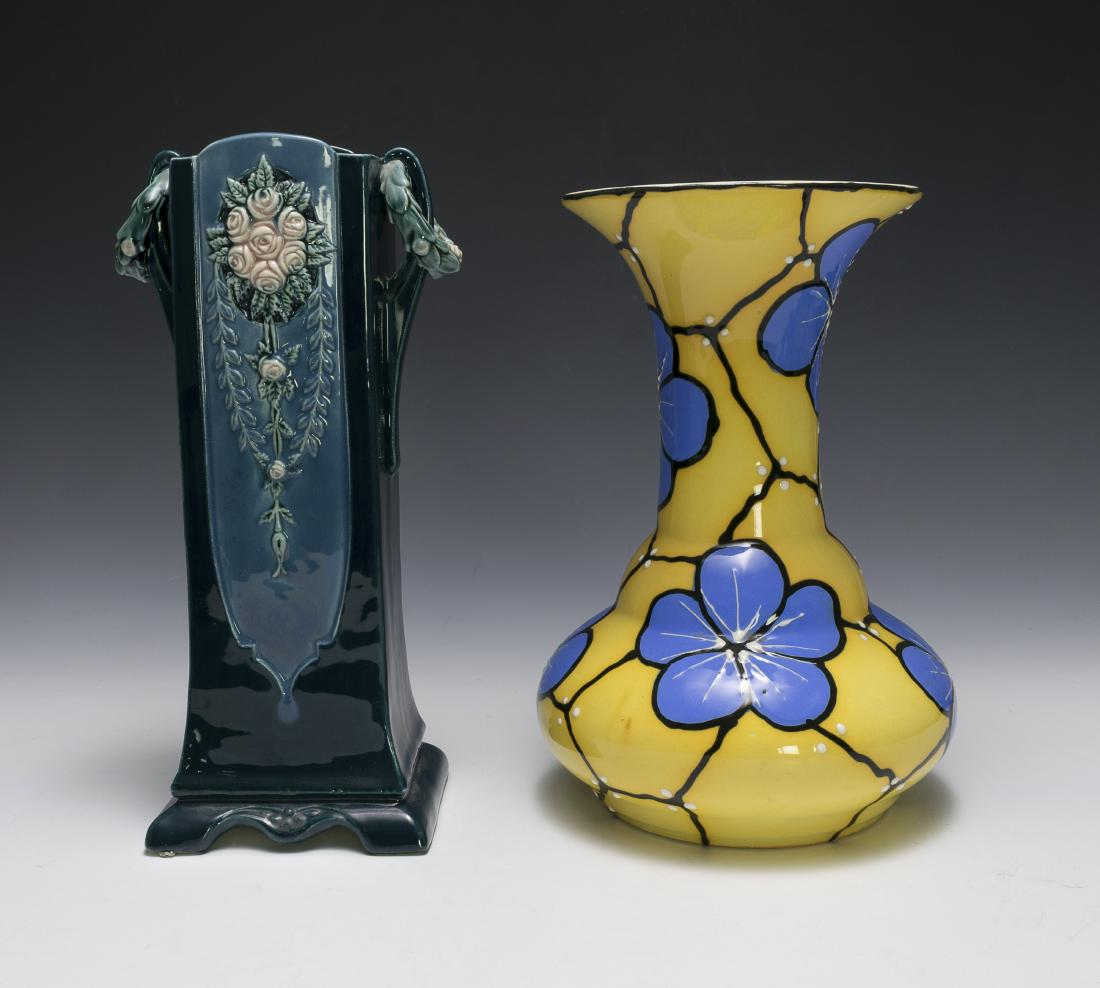 Two Pottery Vases Inc. Eichwald and Czech: Two ceramic vases, one Eichwald and one Czech. The Eichwald vase is dark green, decorated with pink flowers, and stamped "Eichwald 941/5" on base. The Czech vase is yellow and decorated with blue flow