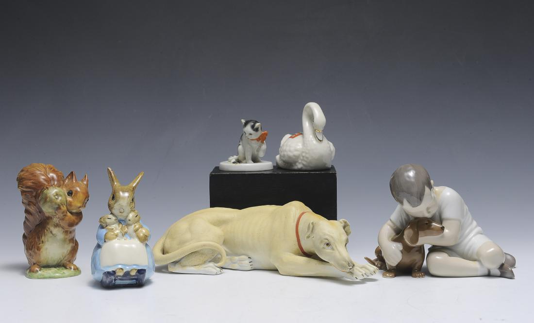 Lot of Six Porcelain Figures: Beswick Mrs. Rabbit and bunnies, Beswick Squirrel Nutkin, Bing & Grondahl boy with dachshund, Dainty Ware crested china swan, Bisque dog and a Full Bee mark Goebel cat with fly. Dimensions are: larges