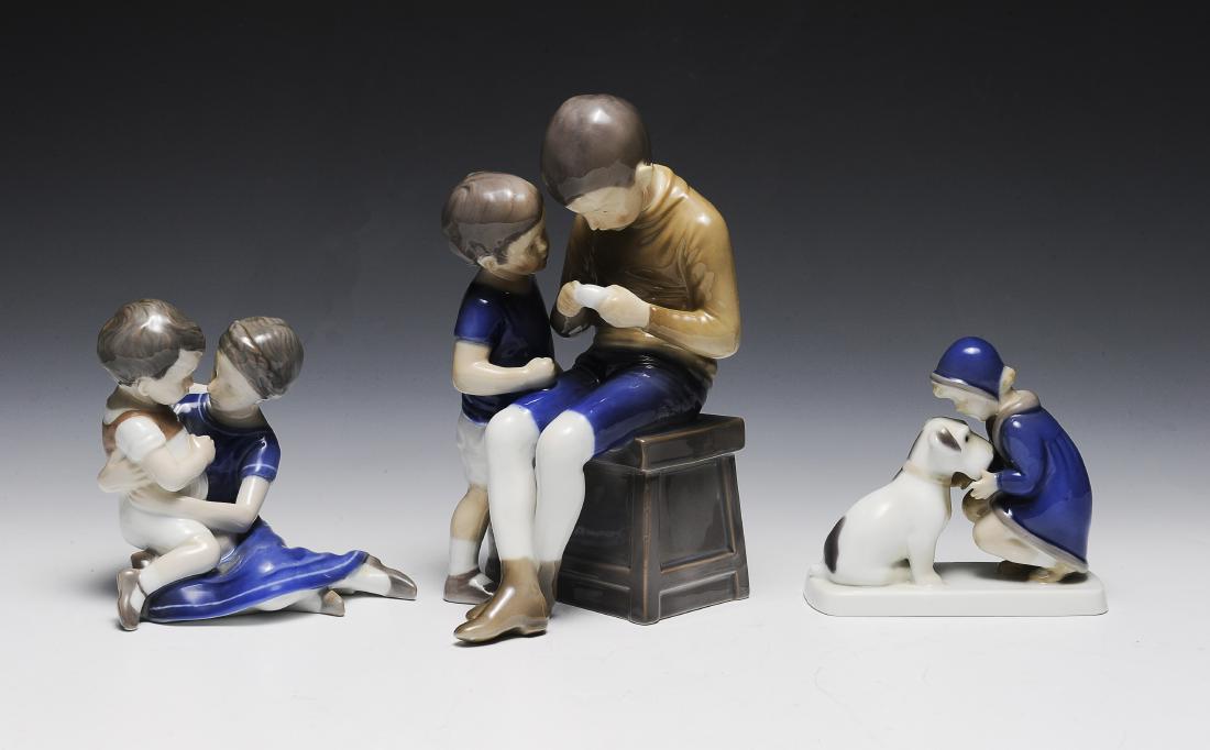 Three Bing & Grondahl Porcelain Figure Groups: Largest is two boys no. 1648, boy and a girl no. 1568, and a girl with dog no. 2163. Dimensions are: largest 7 5/8" tall. All measurements are approximate. Condition: No noted damage. Excellent. Prove