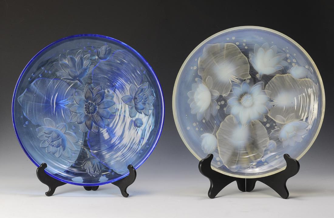 Two Large Verlys Glass Platters w/ Water Lilies: Two large Czech Verlys glass platters that sit on three feet and are decorated with water lilies and frosted glass details. One platter is in Opal and the other is in Royal Blue. Dimensions are: 13 3/
